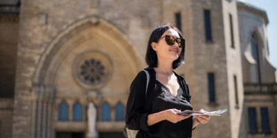 Travel guide, tourism in Europe, woman tourist with map on the street Travel guide, tourism in Europe, woman tourist with map on the street